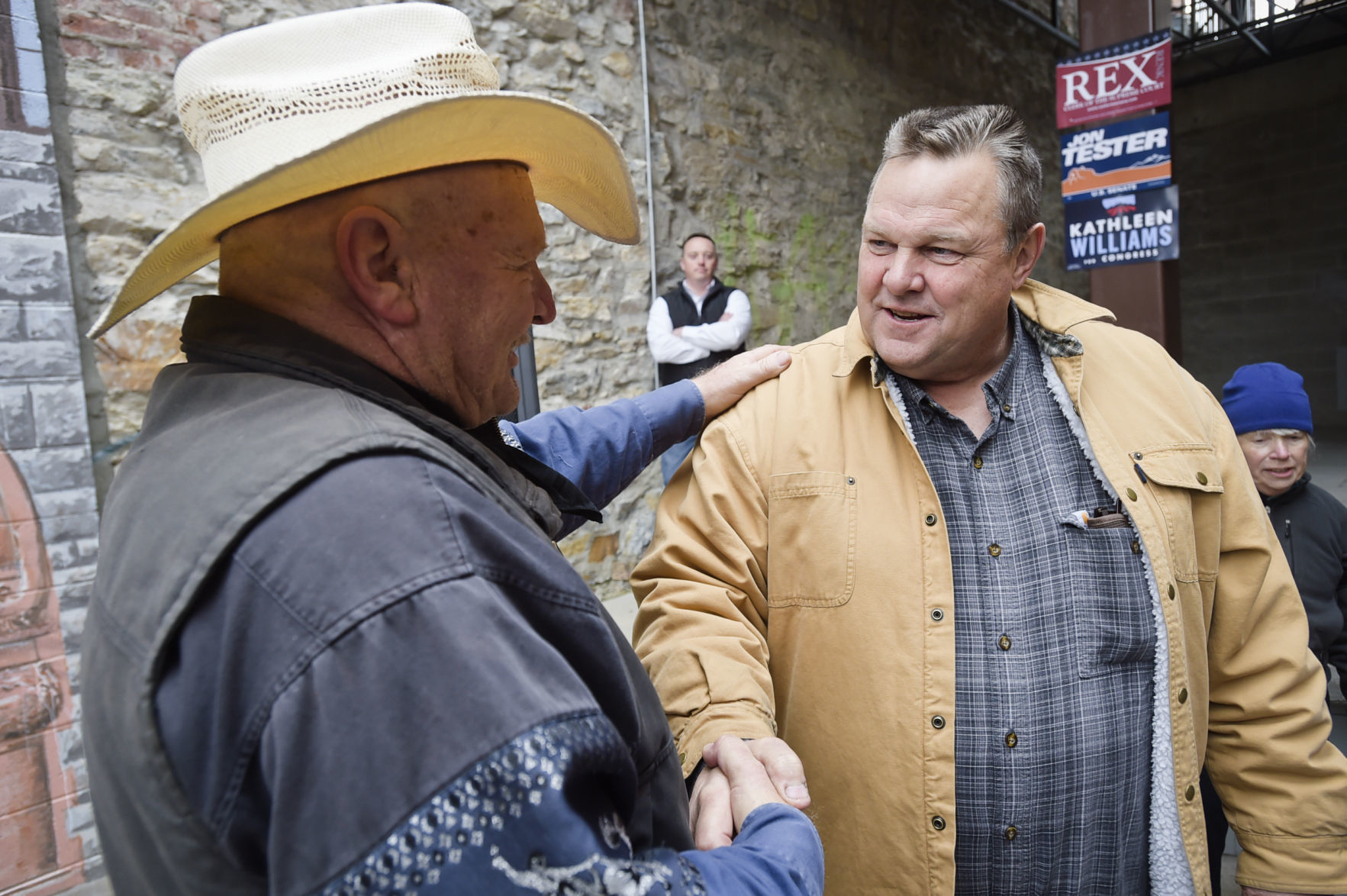 Sen. Jon Tester speaks with a supporter
